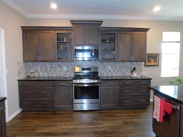 kitchen with ornamental molding, dark brown cabinets, appliances with stainless steel finishes, dark hardwood / wood-style flooring, and decorative backsplash