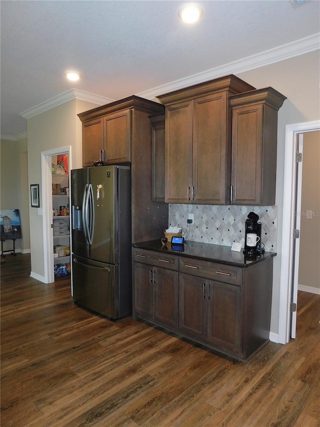 kitchen with decorative backsplash, stainless steel refrigerator with ice dispenser, crown molding, and dark hardwood / wood-style flooring