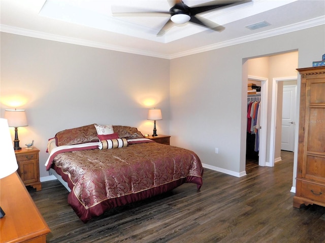 bedroom with crown molding, ceiling fan, and a walk in closet