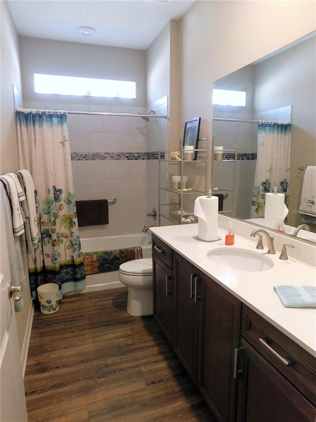 full bathroom with wood-type flooring, vanity, toilet, and shower / tub combo with curtain