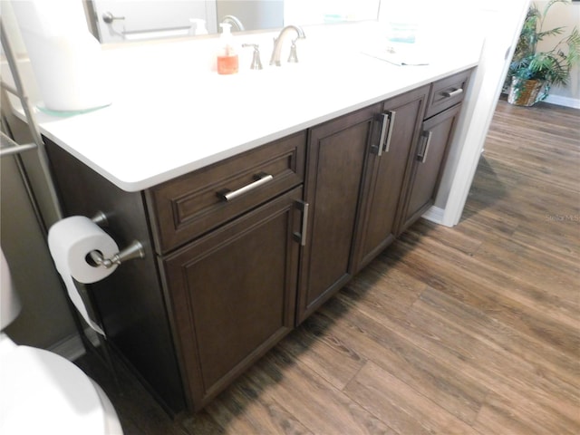 bathroom featuring vanity, toilet, and hardwood / wood-style flooring