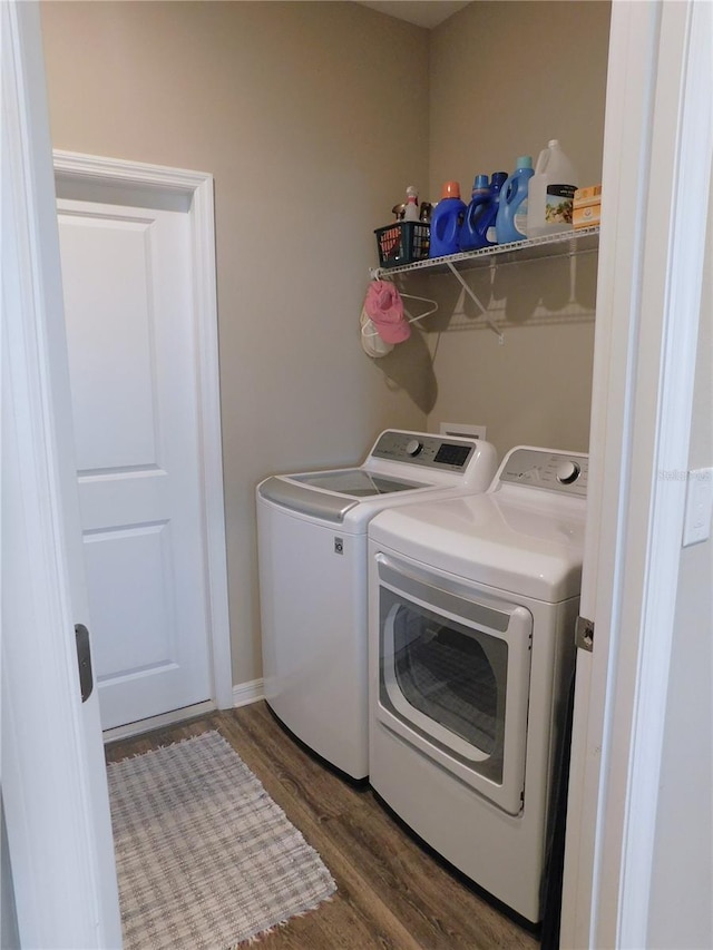 washroom featuring separate washer and dryer and dark hardwood / wood-style flooring