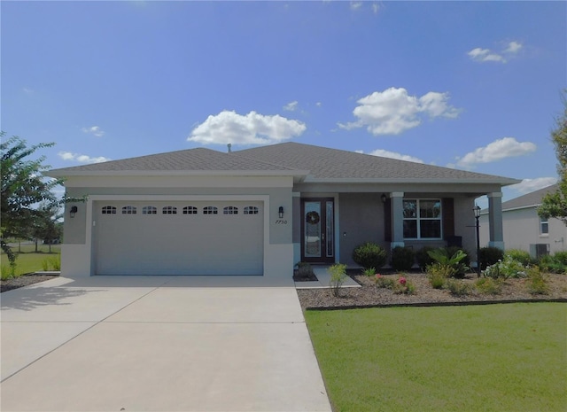 single story home featuring a front lawn, central AC unit, and a garage