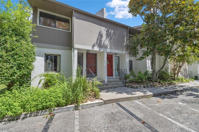 1428 SW 25th Pl, Gainesville, FL 32608 - townhome / multi-family property with uncovered parking and stucco siding