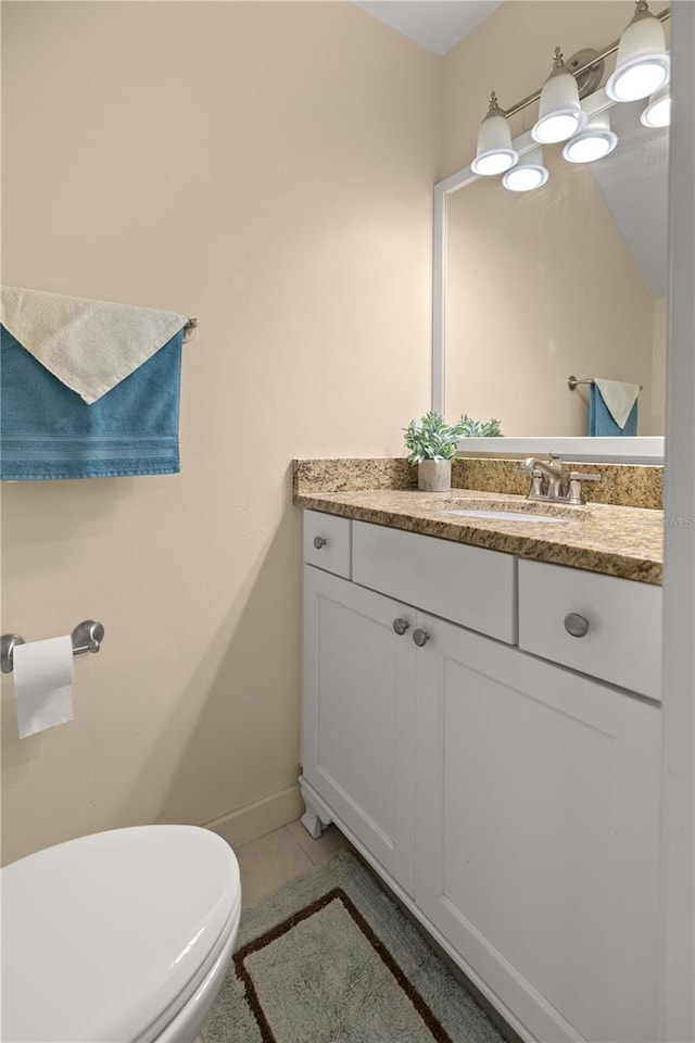 bathroom with tile patterned floors, toilet, and vanity