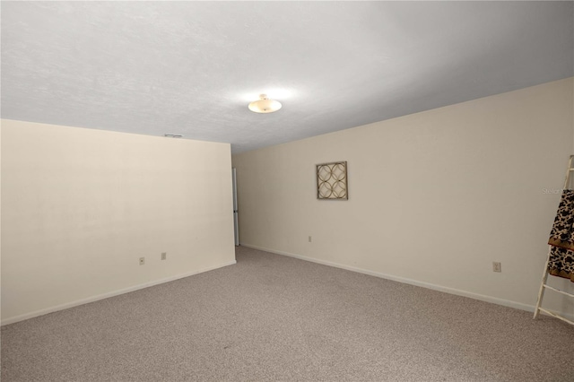 spare room with a textured ceiling and carpet floors