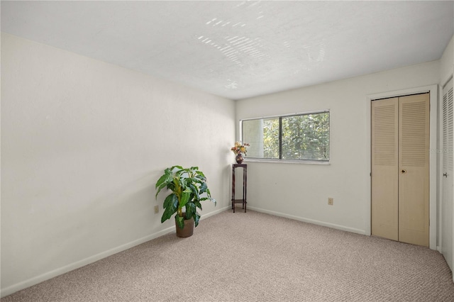 unfurnished bedroom featuring light carpet