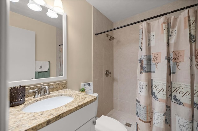 bathroom with toilet, vanity, and curtained shower