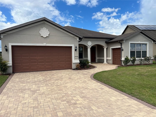 ranch-style house with a garage and a front yard