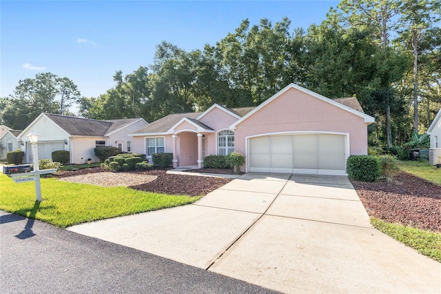 ranch-style home featuring a front lawn and a garage