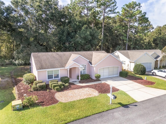 ranch-style home with a garage and a front yard