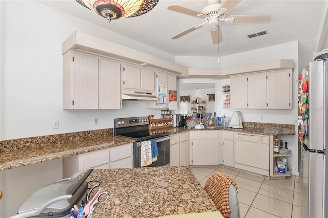 kitchen with ceiling fan, light tile patterned flooring, dark stone counters, white cabinets, and appliances with stainless steel finishes