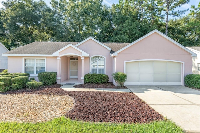 11696 SW 71st Cir, Ocala, FL 34476 - ranch-style home with a garage, concrete driveway, stucco siding, and roof with shingles