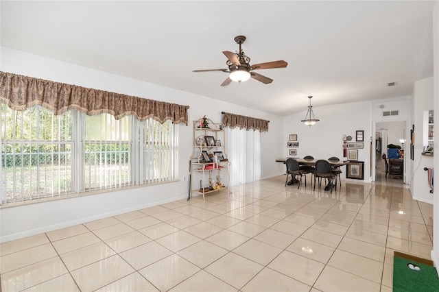 dining room with light tile patterned floors and ceiling fan