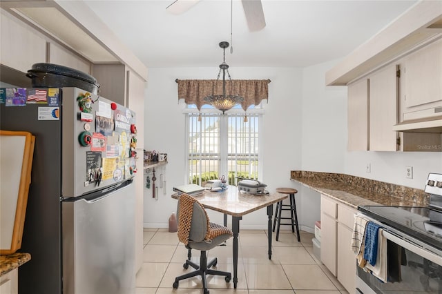 kitchen featuring ceiling fan, light tile patterned floors, pendant lighting, and appliances with stainless steel finishes