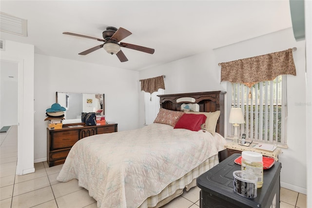 bedroom with ceiling fan and light tile patterned flooring