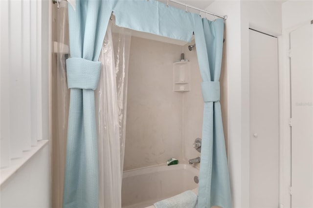 bathroom with shower / bath combo with shower curtain