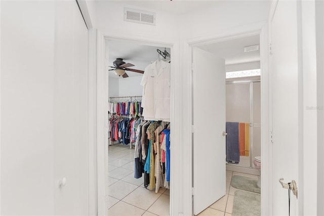 interior space with ceiling fan and light tile patterned floors