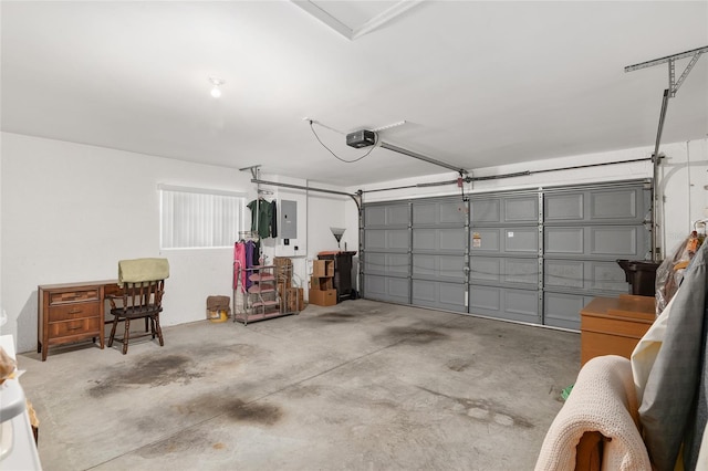 garage featuring electric panel and a garage door opener