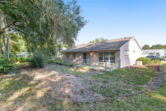 11696 SW 71st Cir, Ocala, FL 34476 - rear view of property with cooling unit, a shingled roof, and stucco siding