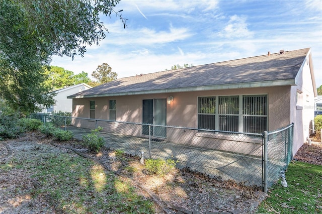 11696 SW 71st Cir, Ocala, FL 34476 - rear view of house with a shingled roof and stucco siding