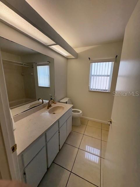11696 SW 71st Cir, Ocala, FL 34476 - bathroom featuring toilet, tile patterned flooring, vanity, and healthy amount of natural light