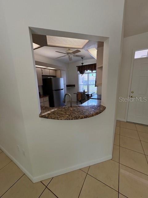 11696 SW 71st Cir, Ocala, FL 34476 - kitchen featuring freestanding refrigerator, baseboards, tile patterned floors, and ceiling fan