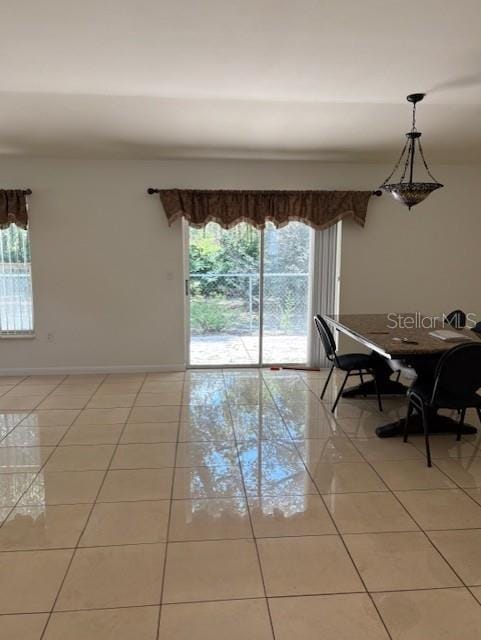 11696 SW 71st Cir, Ocala, FL 34476 - dining room featuring light tile patterned floors and baseboards
