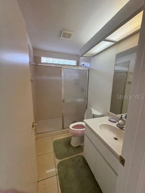 11696 SW 71st Cir, Ocala, FL 34476 - bathroom with tile patterned floors, vanity, a shower stall, and toilet