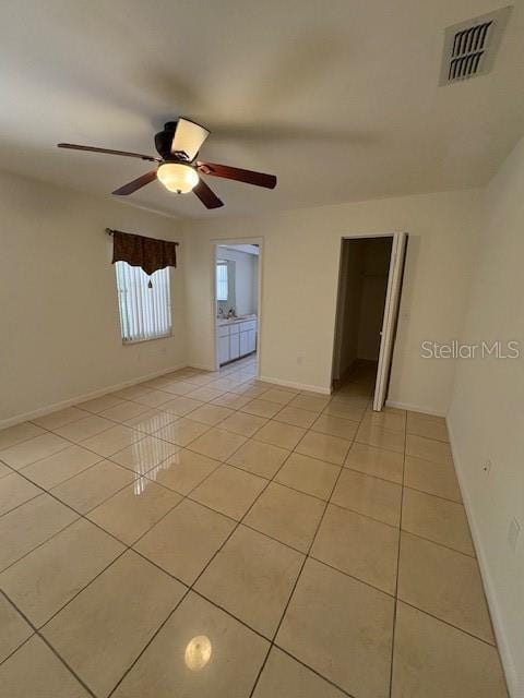 11696 SW 71st Cir, Ocala, FL 34476 - spare room with light tile patterned flooring, ceiling fan, and baseboards