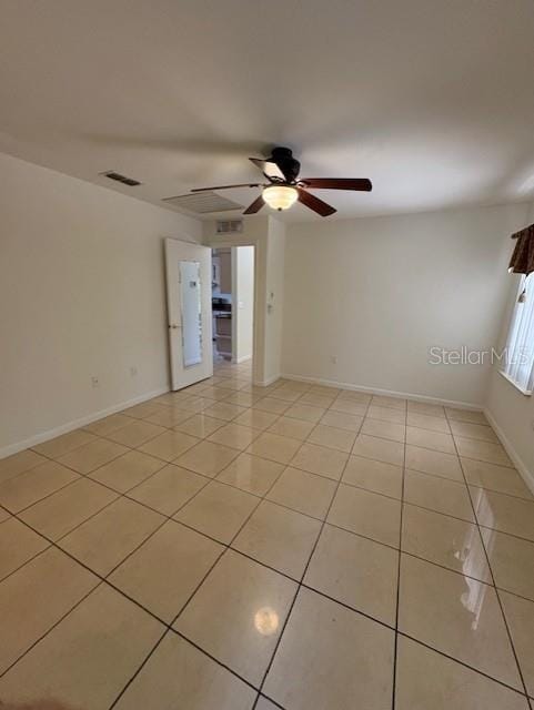 11696 SW 71st Cir, Ocala, FL 34476 - spare room featuring light tile patterned floors, ceiling fan, and baseboards