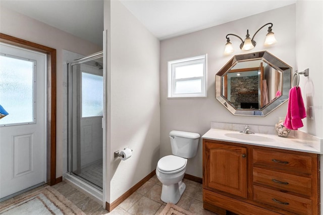 bathroom featuring tile patterned floors, vanity, toilet, and a shower with shower door