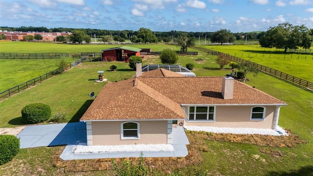 birds eye view of property with a rural view