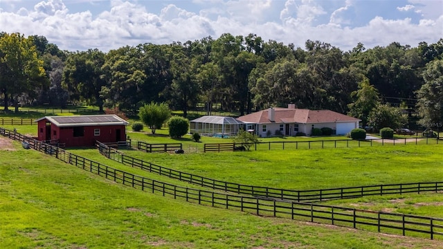 view of yard featuring a rural view and an outdoor structure