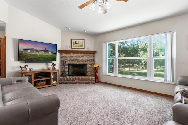 carpeted living room with a fireplace, ceiling fan, and lofted ceiling