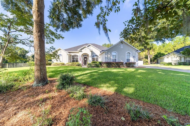 single story home featuring a front yard