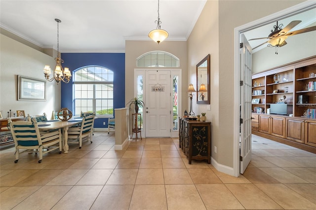 tiled foyer featuring ceiling fan with notable chandelier and ornamental molding