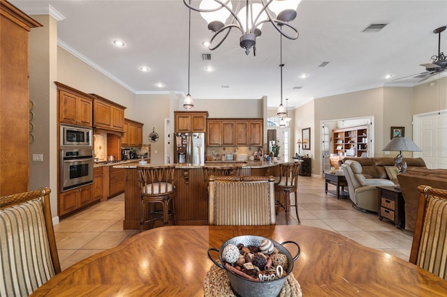 interior space featuring light tile patterned floors, ceiling fan with notable chandelier, and crown molding