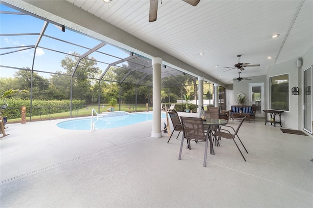 view of swimming pool with ceiling fan, a patio, and a lanai