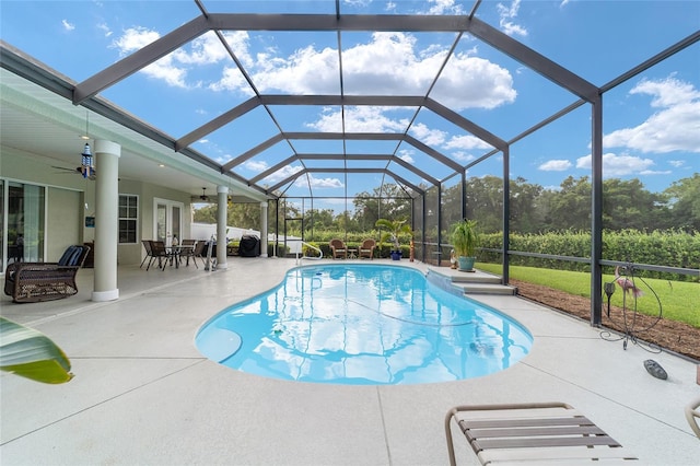 view of swimming pool featuring ceiling fan and a patio