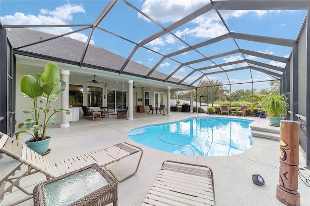 view of pool with ceiling fan, a patio, and a lanai