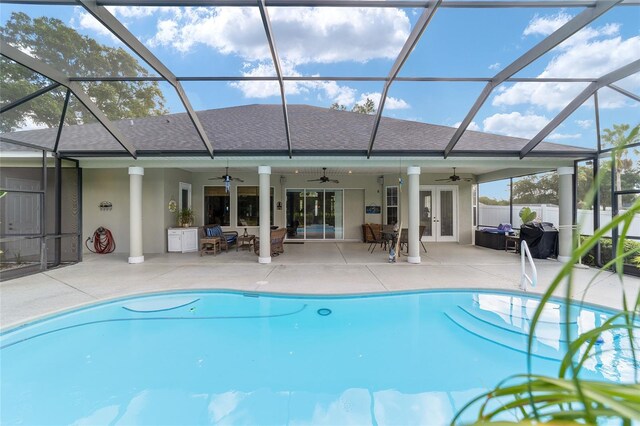 view of pool with ceiling fan, a patio, french doors, and a lanai