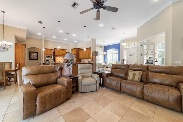 living room featuring crown molding, ceiling fan with notable chandelier, and light tile patterned floors