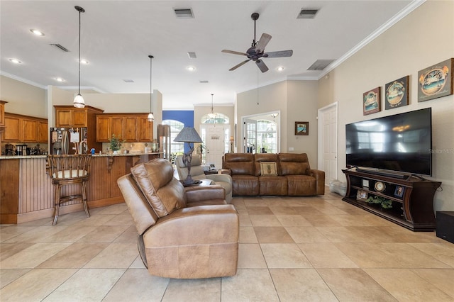 living room with ceiling fan, crown molding, and light tile patterned floors