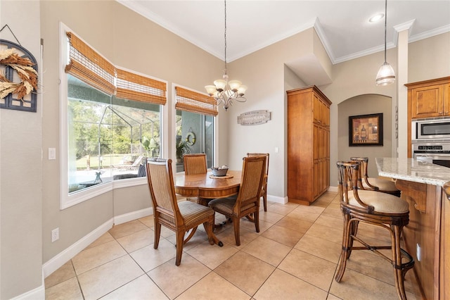 dining room with crown molding, a chandelier, and light tile patterned floors