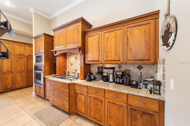 kitchen featuring light tile patterned floors, stainless steel appliances, ornamental molding, and tasteful backsplash