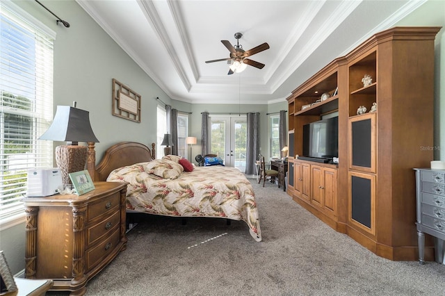 carpeted bedroom with multiple windows, a raised ceiling, access to outside, and ceiling fan