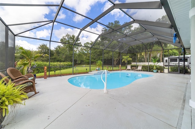 view of swimming pool featuring a patio area, glass enclosure, and a yard