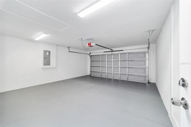 garage with a garage door opener and electric panel