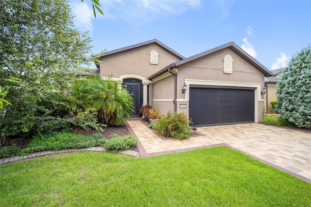 view of front of home with a front yard and a garage